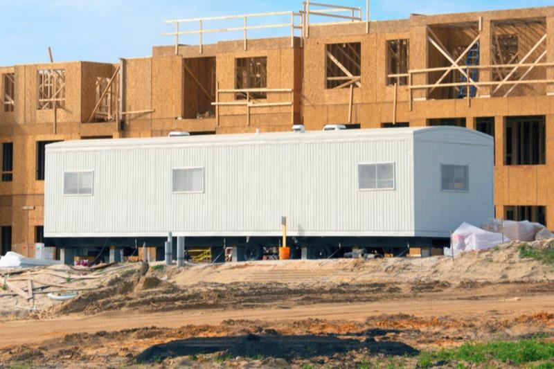 a temporary office trailer with skylights and air conditioning units in Lisbon